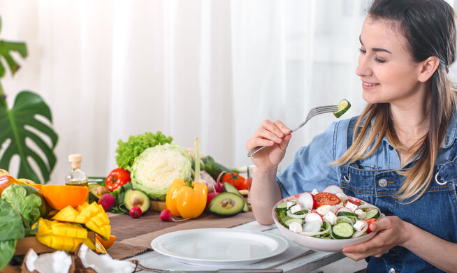 Young and happy woman eating healthy diet for weight loss and muscle gain